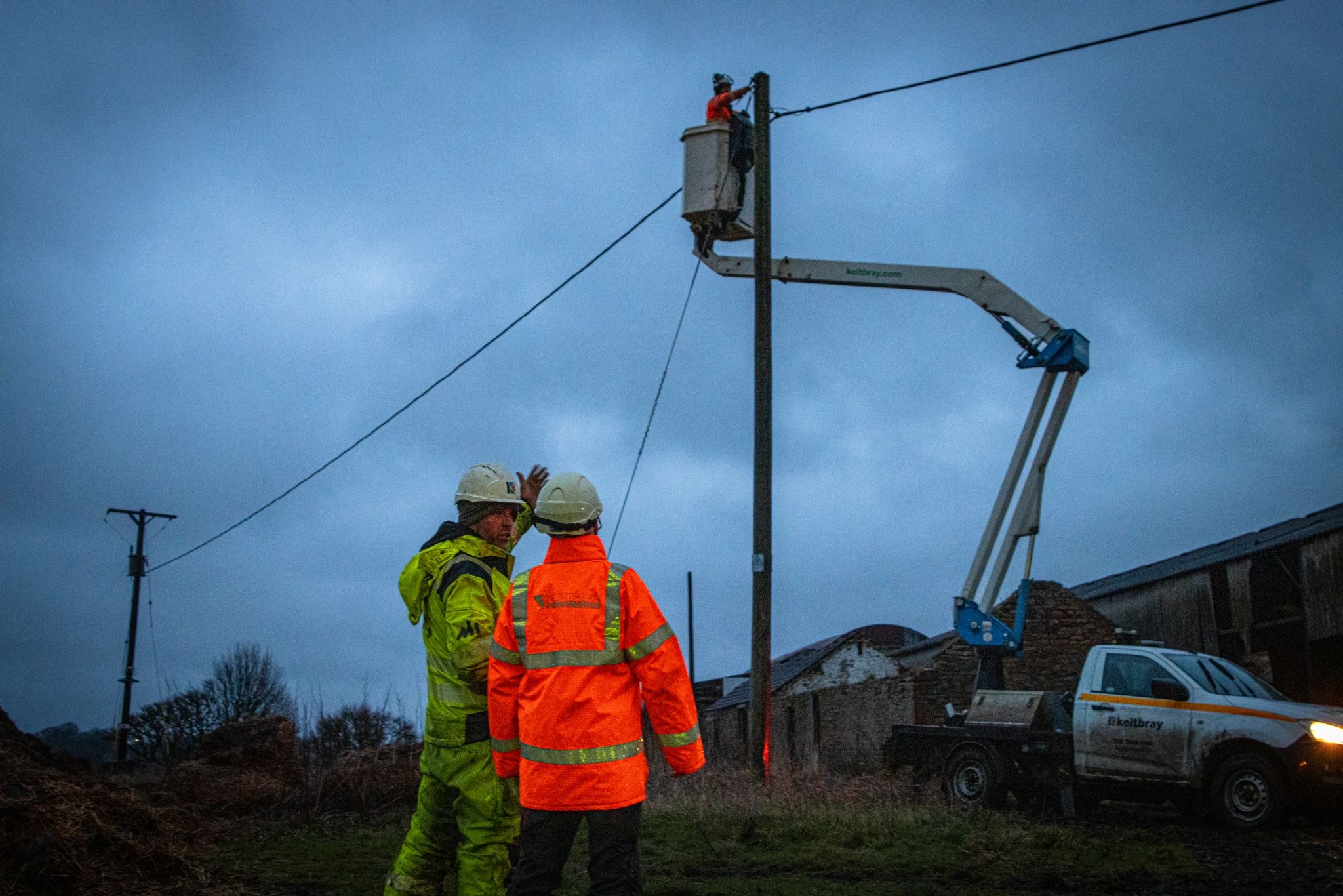 Two NPg colleagues discussing the repair of a line in the background