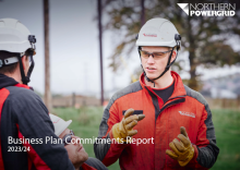 Front cover of Business Plan Commitments Report 2023-24 with image of two Norhern Powergriengineers talking