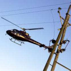 Helicopter flying near overhead power line
